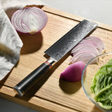 Home & Beyond Co Damascus chef kitchen knife set with multiple stainless steel knives on a wooden surface.